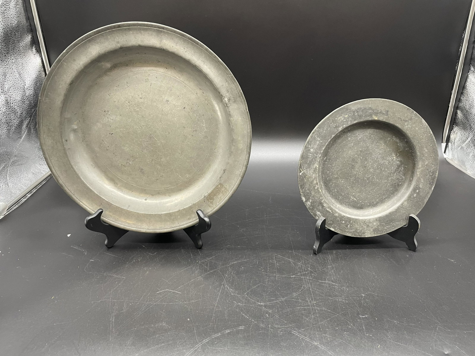 Two Pieces 18thC/19thC Pewter: Large charger 13"W, unsigned. Smaller plate marked London, 9"W. Both wear with age.