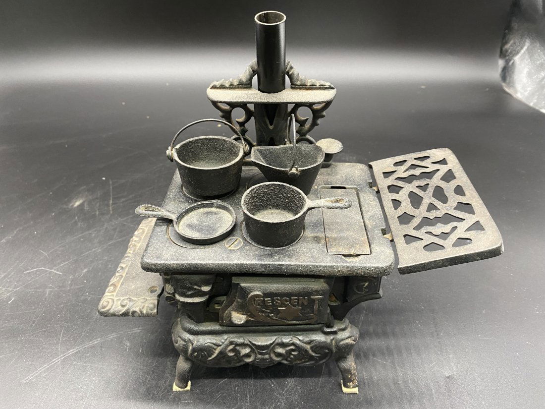 Cast Iron crescent Saleman's Sample Stove: Stove measures 13"H X 5"W and includes accessories