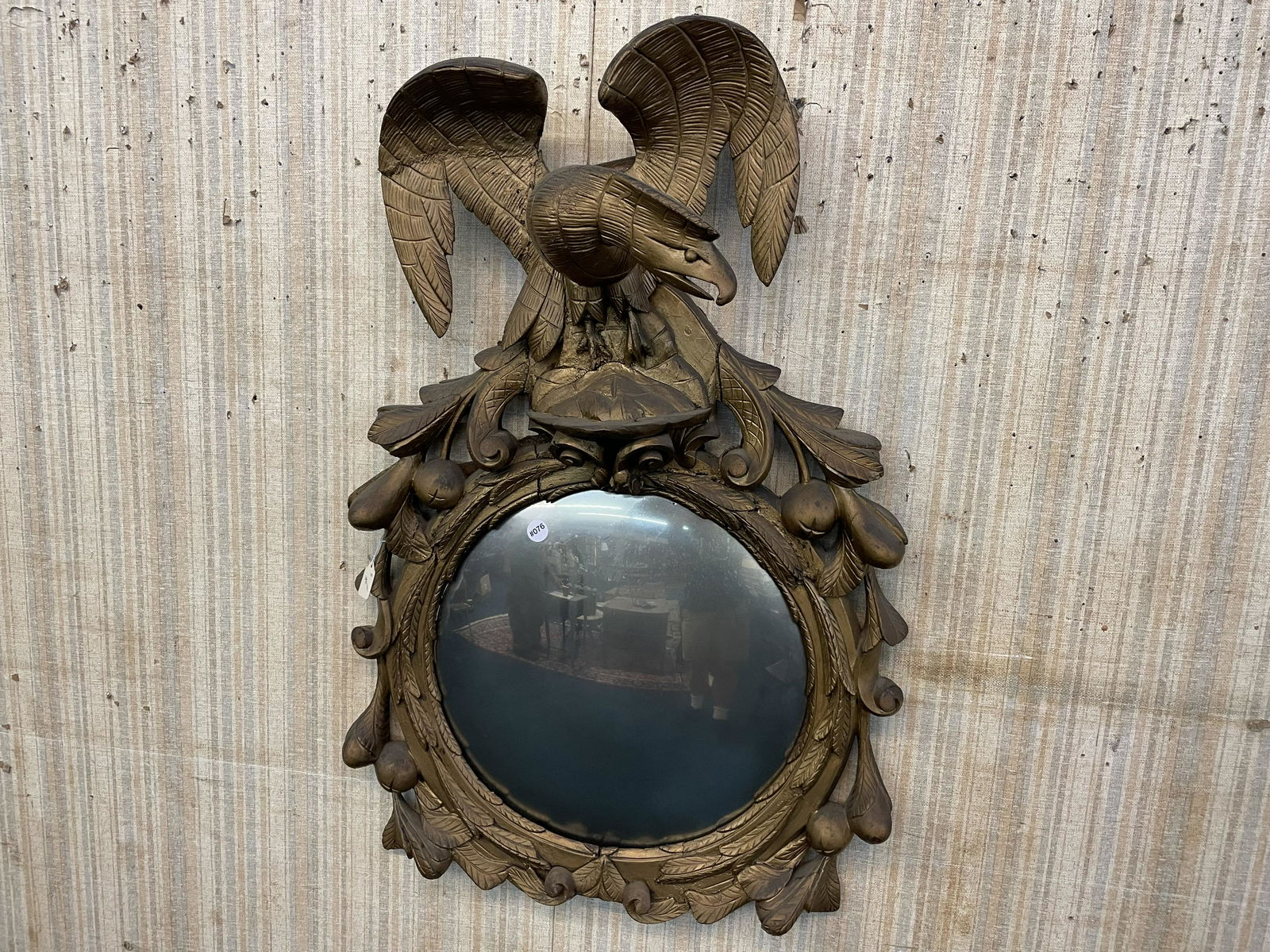 Outstanding Centennial Bullseye Mirror With Eagle: Measures 40" H x 25" W. Depicts an exaggerated eagle with leaves & various fruits surrounding. Has original bowed glass, repair to one wing. Common separation just below feet of eagle. Fruit & leaves