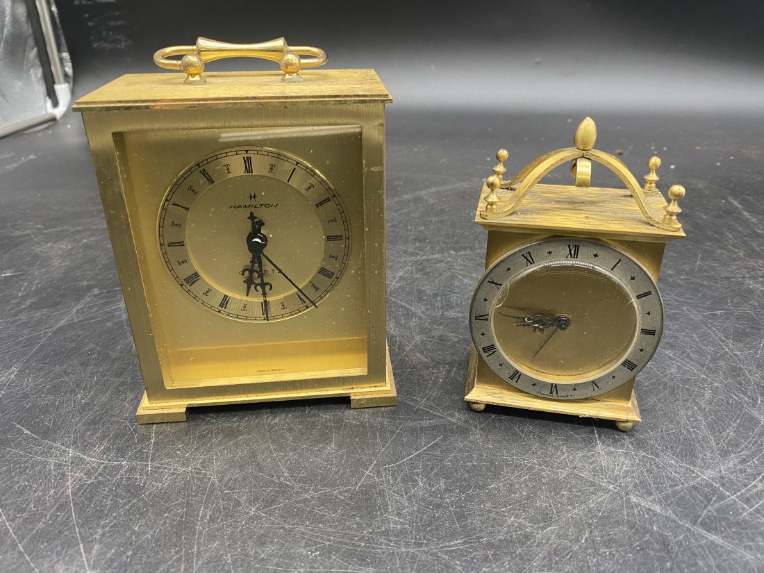 Two Carriage Clocks: One marked France, measures 5" x 3". Other is a Hamilton, measures 6" x 4".