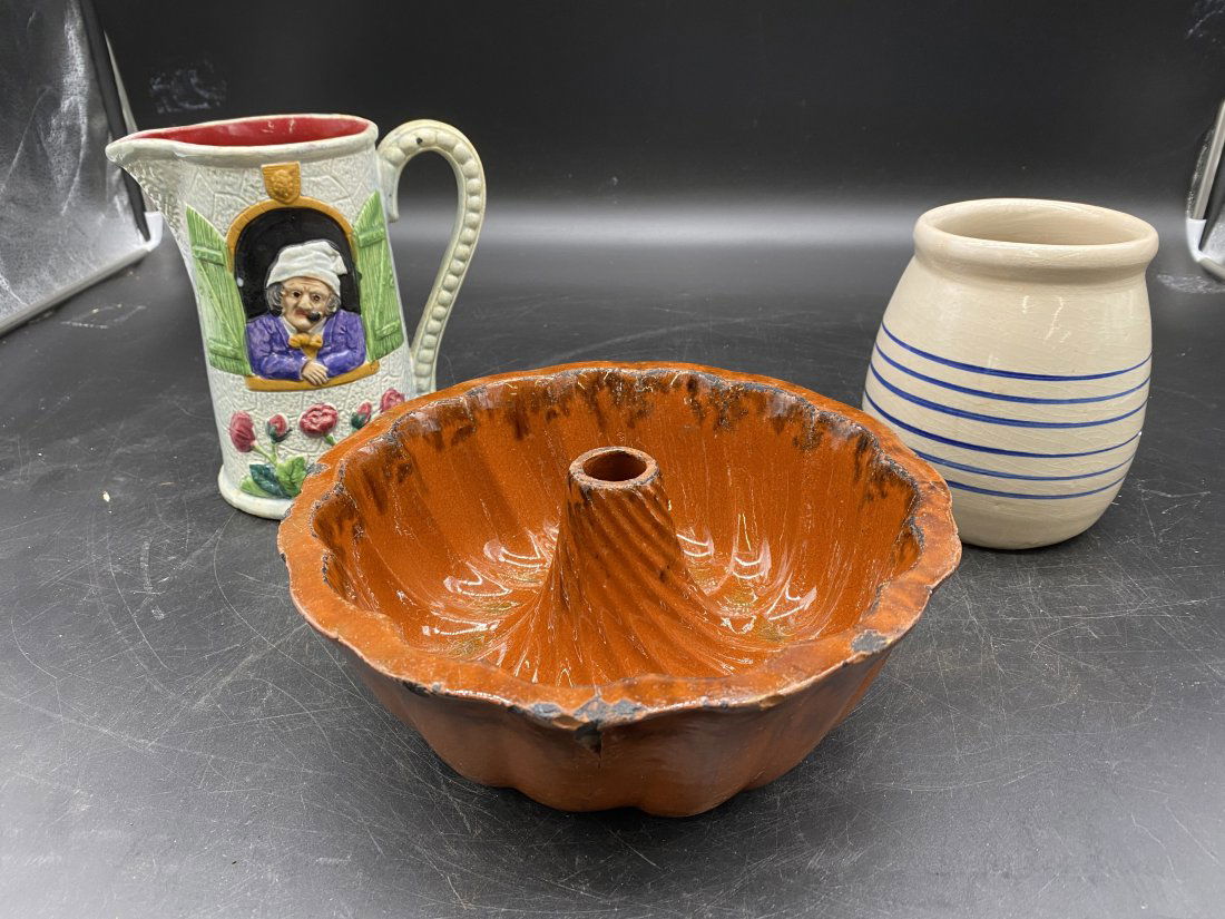 Pottery Lot: Majolica pitcher is 8"x7", redware mold is 4"x9", along with a 6"H stoneware jar