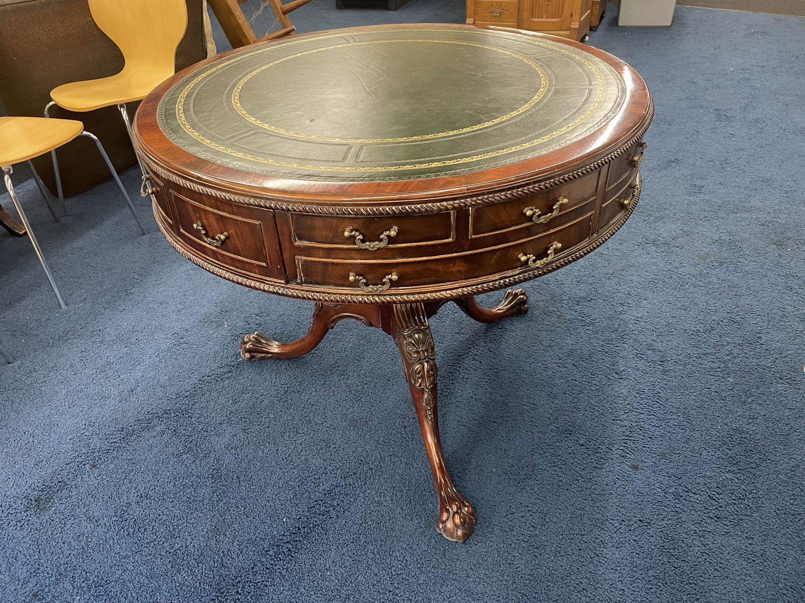 Carved Mahogany Drum Table: leather top, ornatly carved, 32"x36".