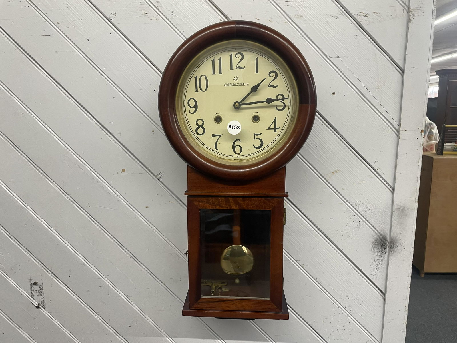 Geo. Blake Clock Co, Wall Clock: signed on face, key pendulum present. 23"x11".