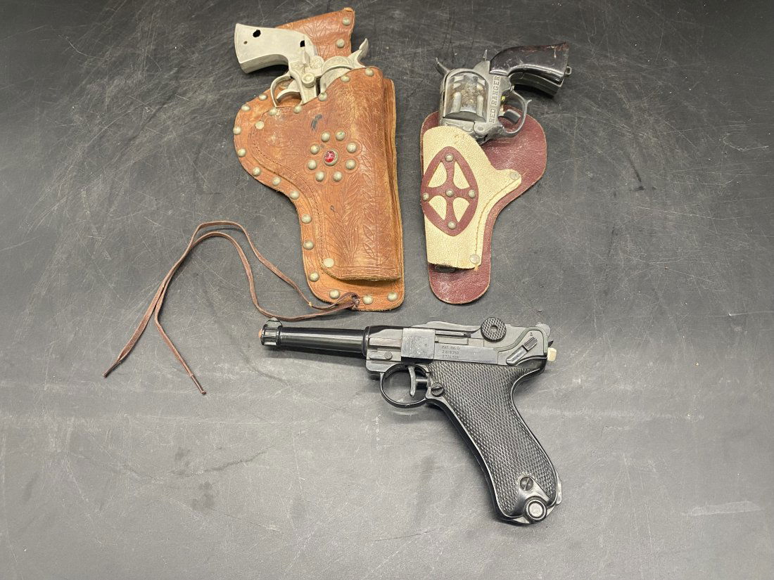 Two Antique Child's Cap Guns and Squirt Gun: Red Ranger in holster is 9" long, marshall in holster is 12", along with squirt gun