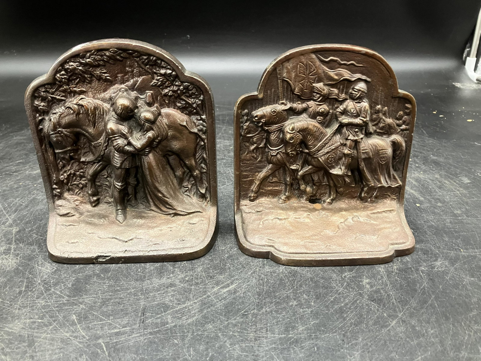 Two Cast Iron Bookends: Both marked on back with different numbers.