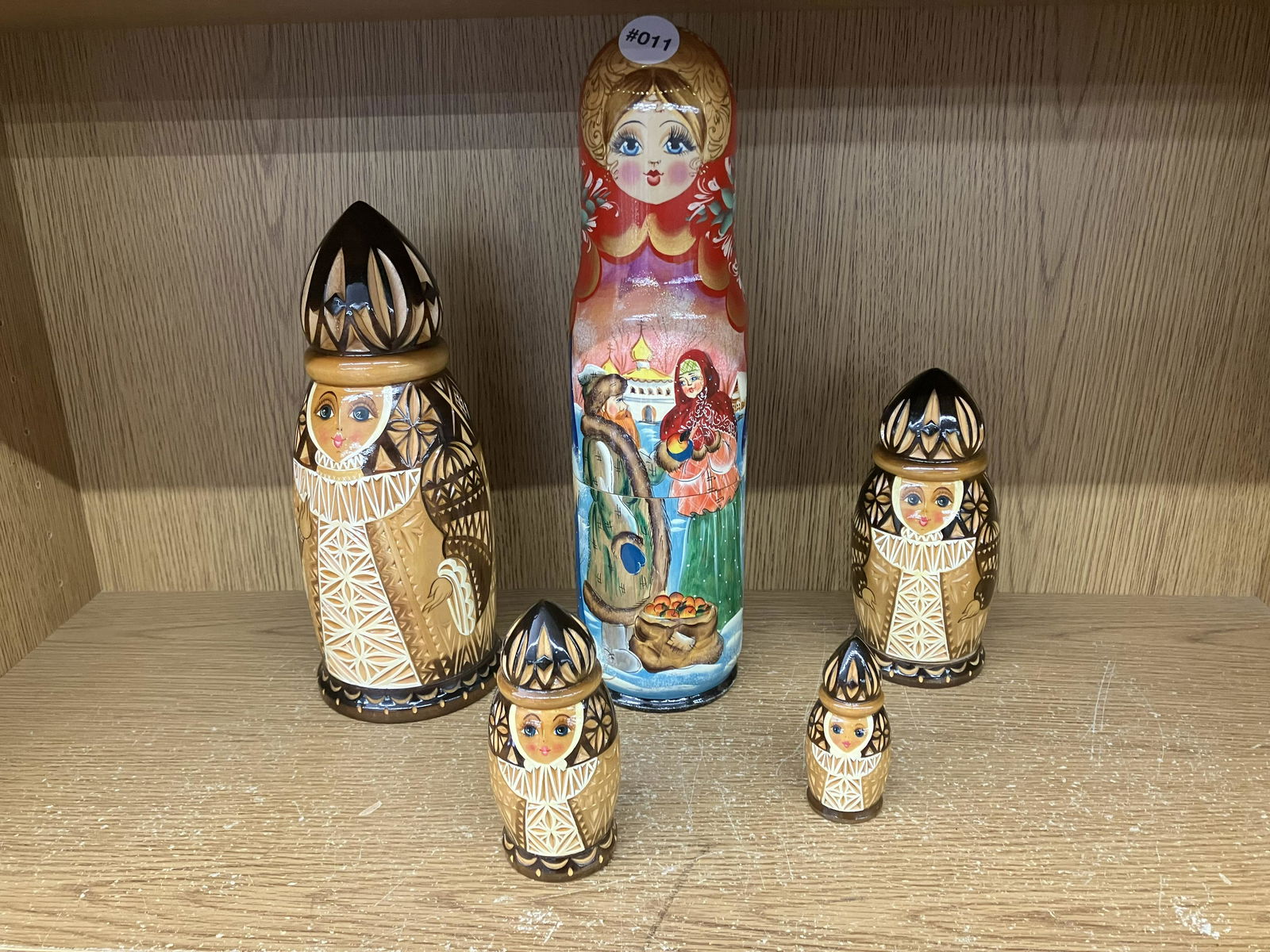 Grouping of Russian Nesting Dolls: Matching set of four, largest 14"H. Hand painted. Plus one extran.