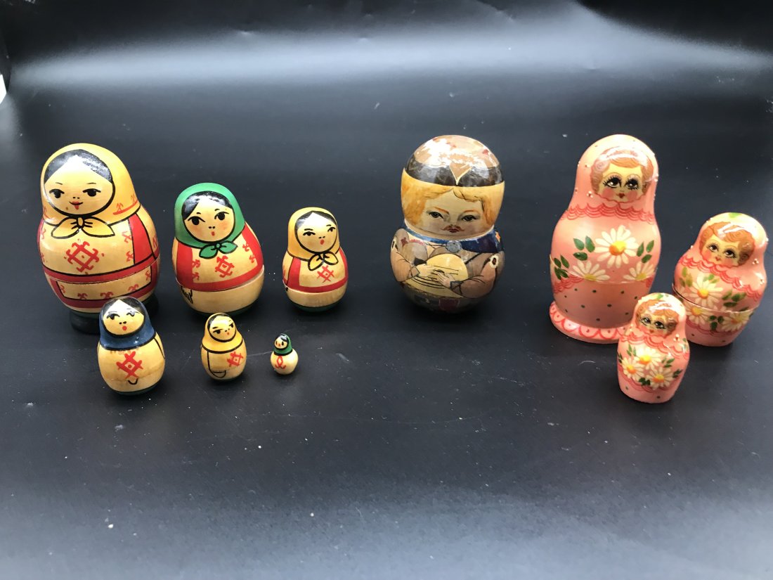 Two Sets Of Russian Nesting Dolls & A Russian Pin Cushion: Two sets of Russian nesting dolls. One set of six and one set of three. Also, a pin cushion. Largest measures 4" H. Hand painted.