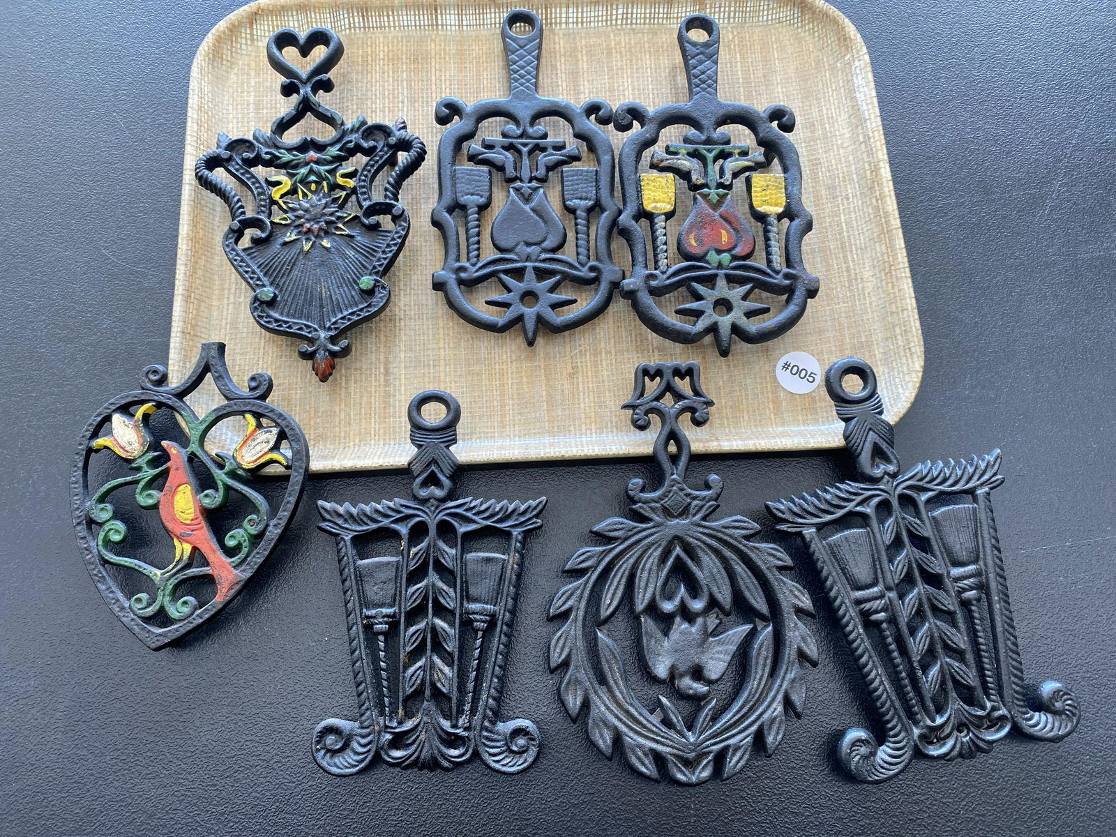 Seven Metal Trivets: Largest one measures 9" L.