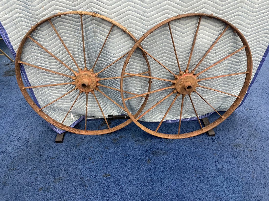 Pair of Antique Iron Tractor Wheels: Measure 36" round, heavy steel.
