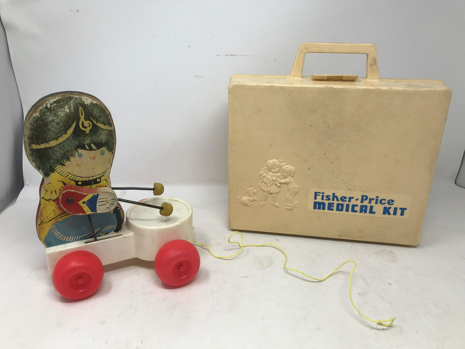 Vintage Toy Lot: Includes a pull along drummer boy and Fisher-Price Medical kit.