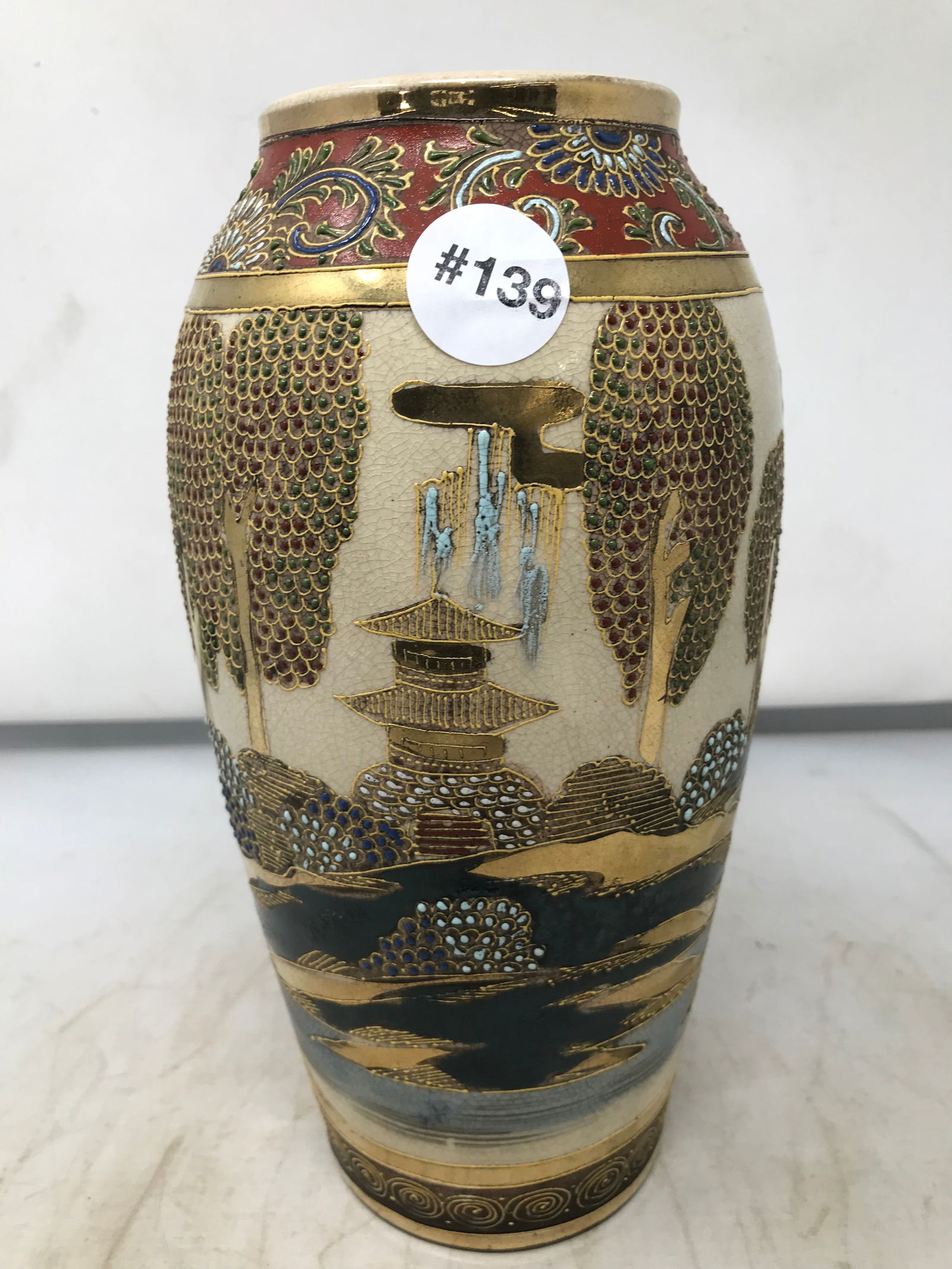 Earthenware Satsuma Vase: pagoda design with raised enamel decoration. 10"H.