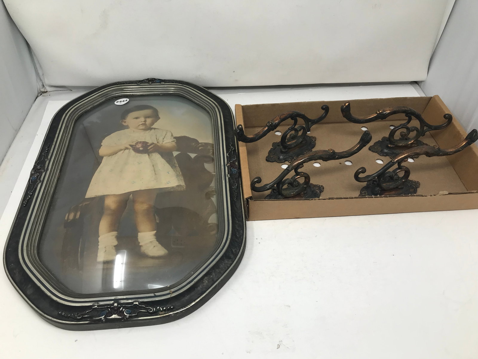 Cast Iron Hooks & Baby Photo: Photo 18" x12", bowed glass front. Four matching hooks 7".