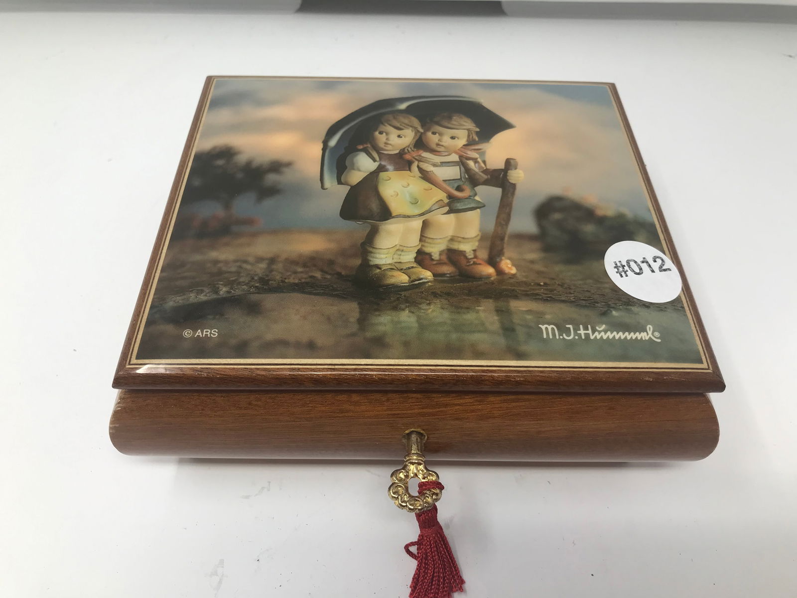 MJ Hummel Swiss Music Box: "rain drops keep fallin on my head". 7"x7".