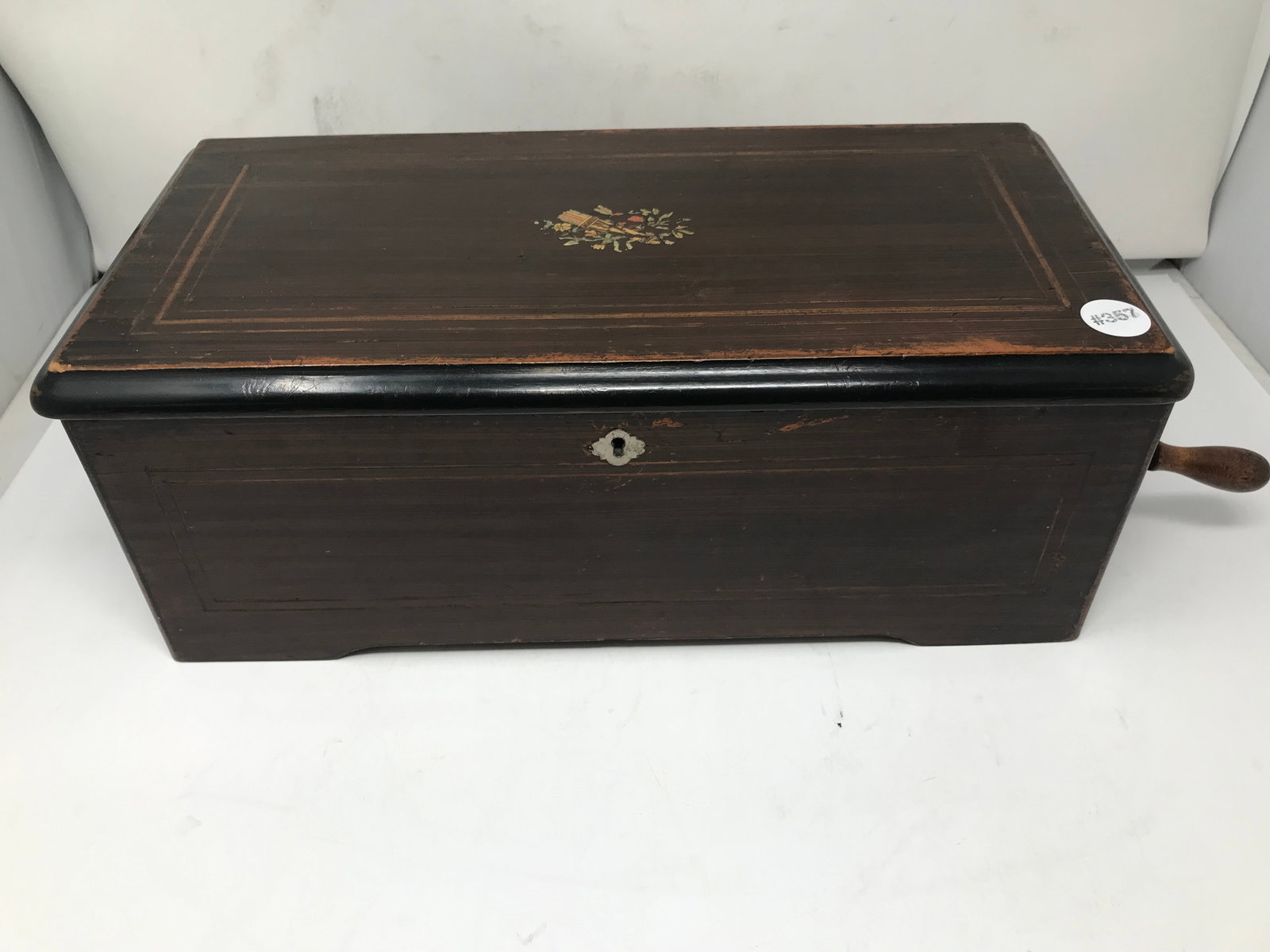 Antique Swiss Music Box: Rosewood case with inlay measures 6" x 17" x 9". Includes crank.