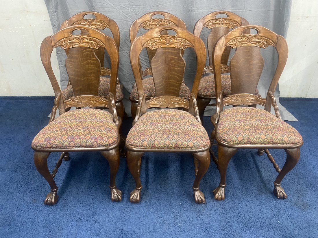 Set of Six Polaski Oak Chairs: 39" x 20" x x17" , matching upholstery, sits on front ball and claw feet with carved balloon backs