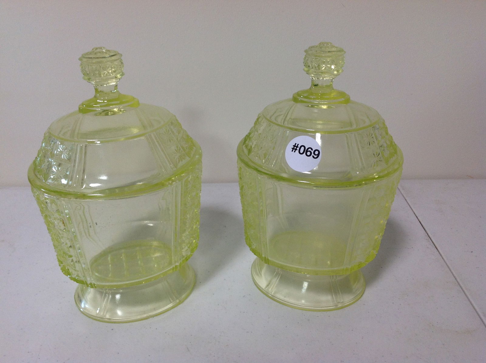 Two Vaseline Glass Covered Jars: larger is 8"x5"