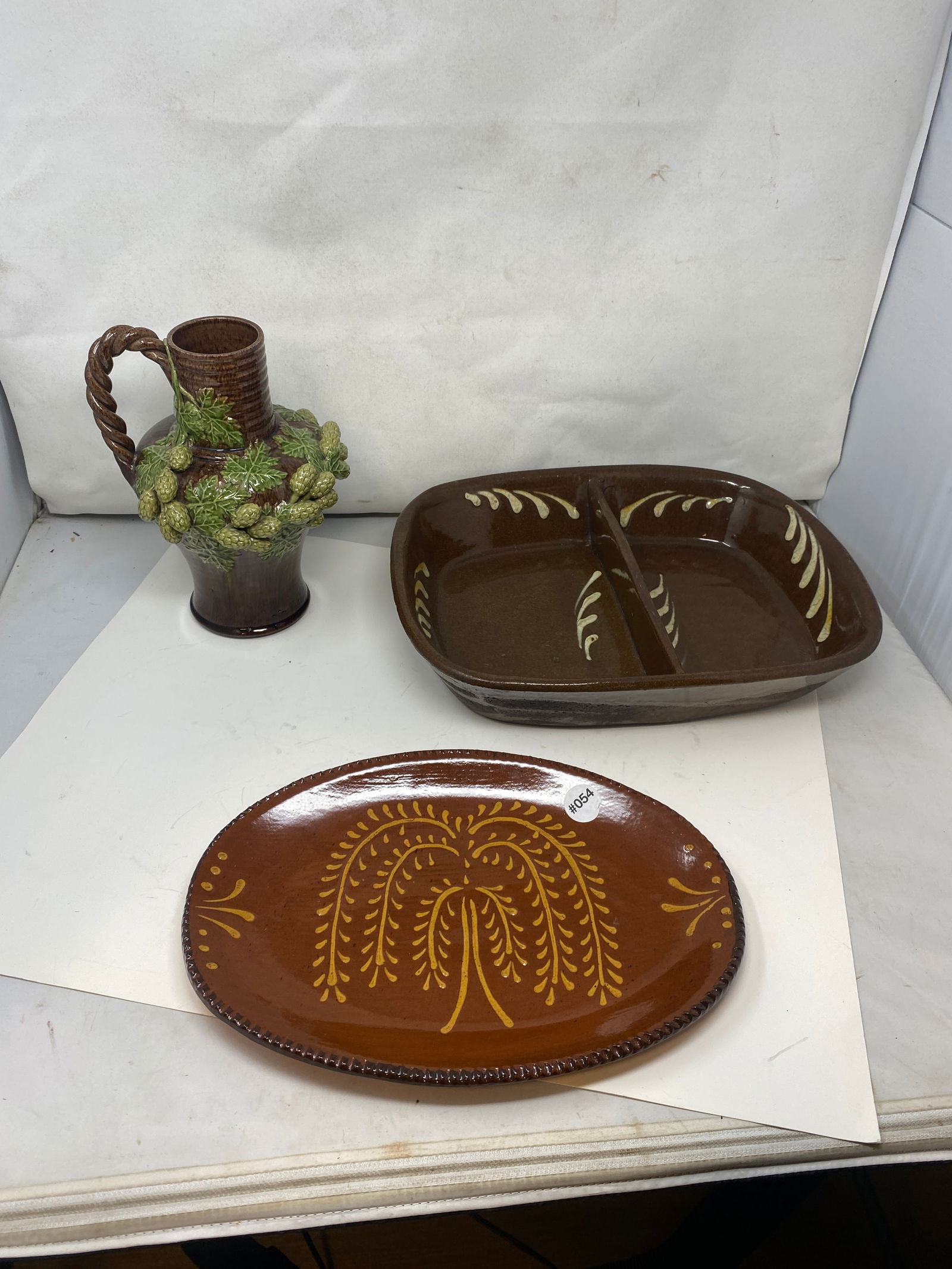 Redware and Pottery: signed platter is 13" x 9", divided bowl is 15" x 12", along with signed pottery ewer