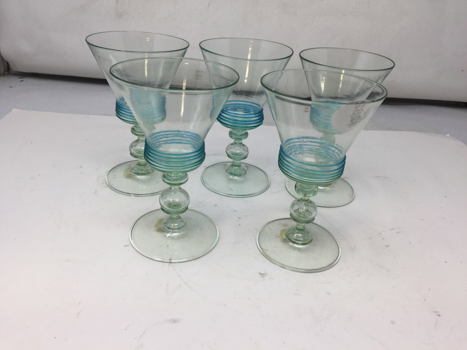 (5) Carder Steuben Wine Stems: applied blue ribbed decoration, blown glass bases, 5"H.