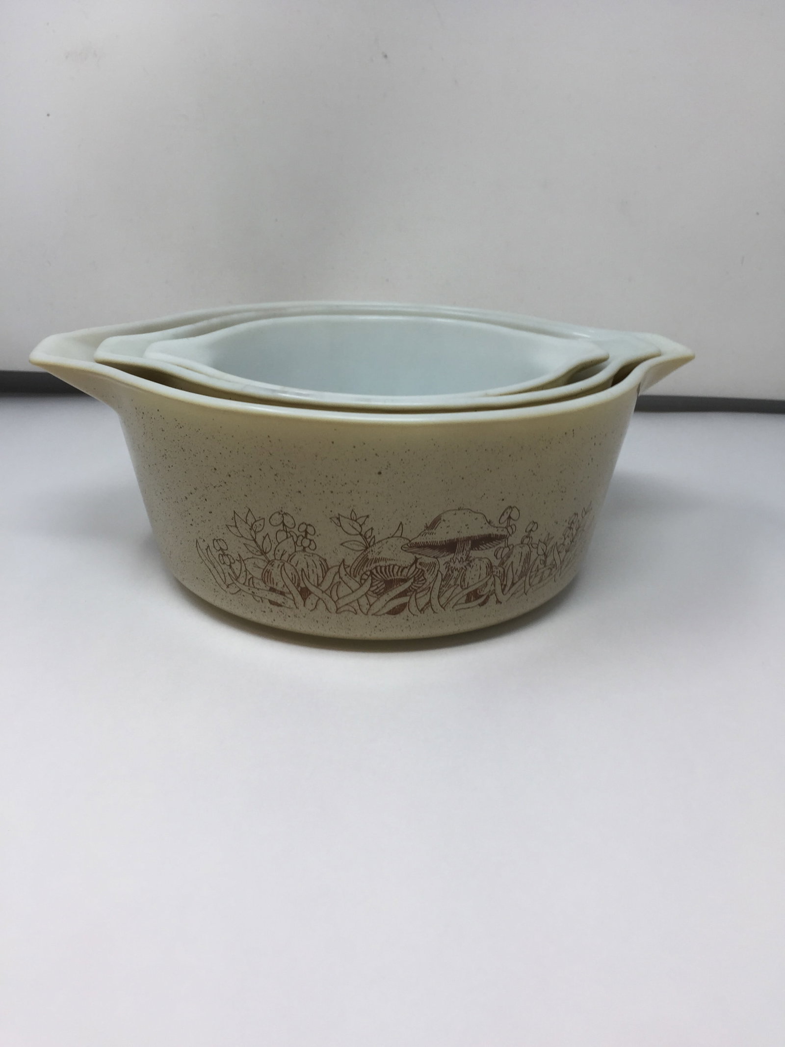 Nest of Three Pyrex Bowls: largest is 4" x 11", smallest is 3" x 7", has mushroom design