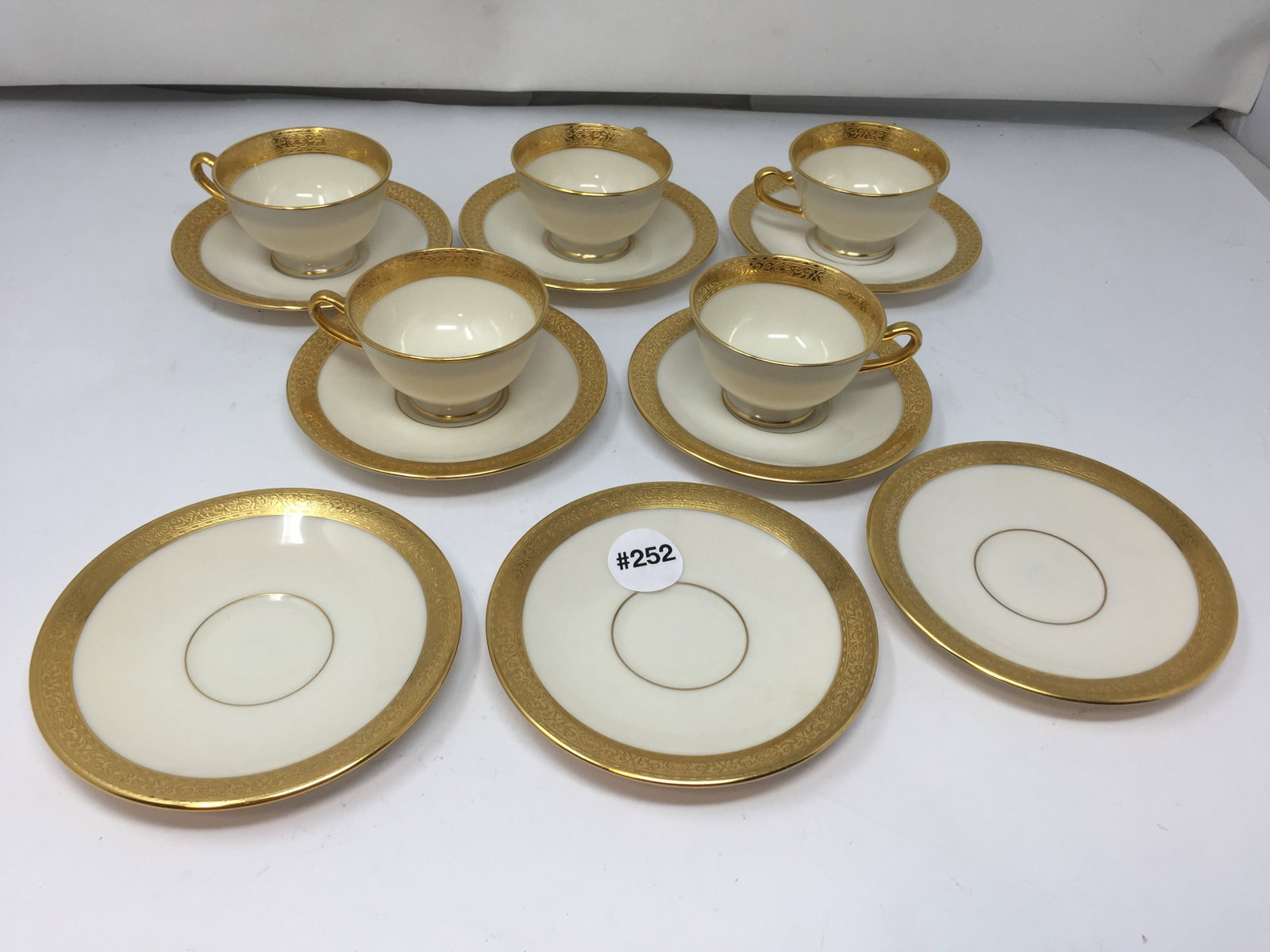 Lenox Gold Encrusted Cups & Saucers: 5 cups with eight saucers. All marked & numbered. Saucers 5" W.