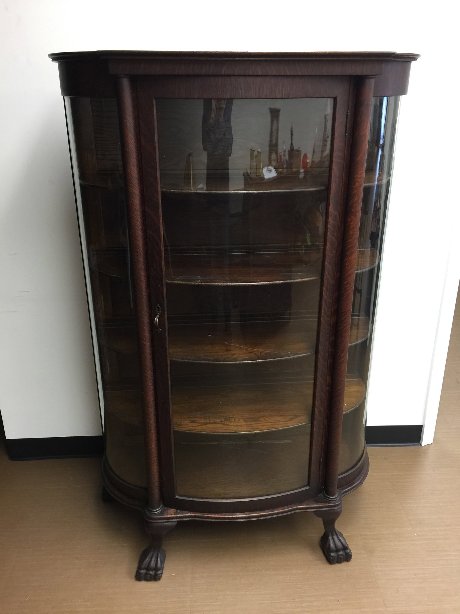Antique Oak China Cabinet: 62" x 40" x 16", has curved glass sides and bowed glass door, sits on heavily carved claw feet