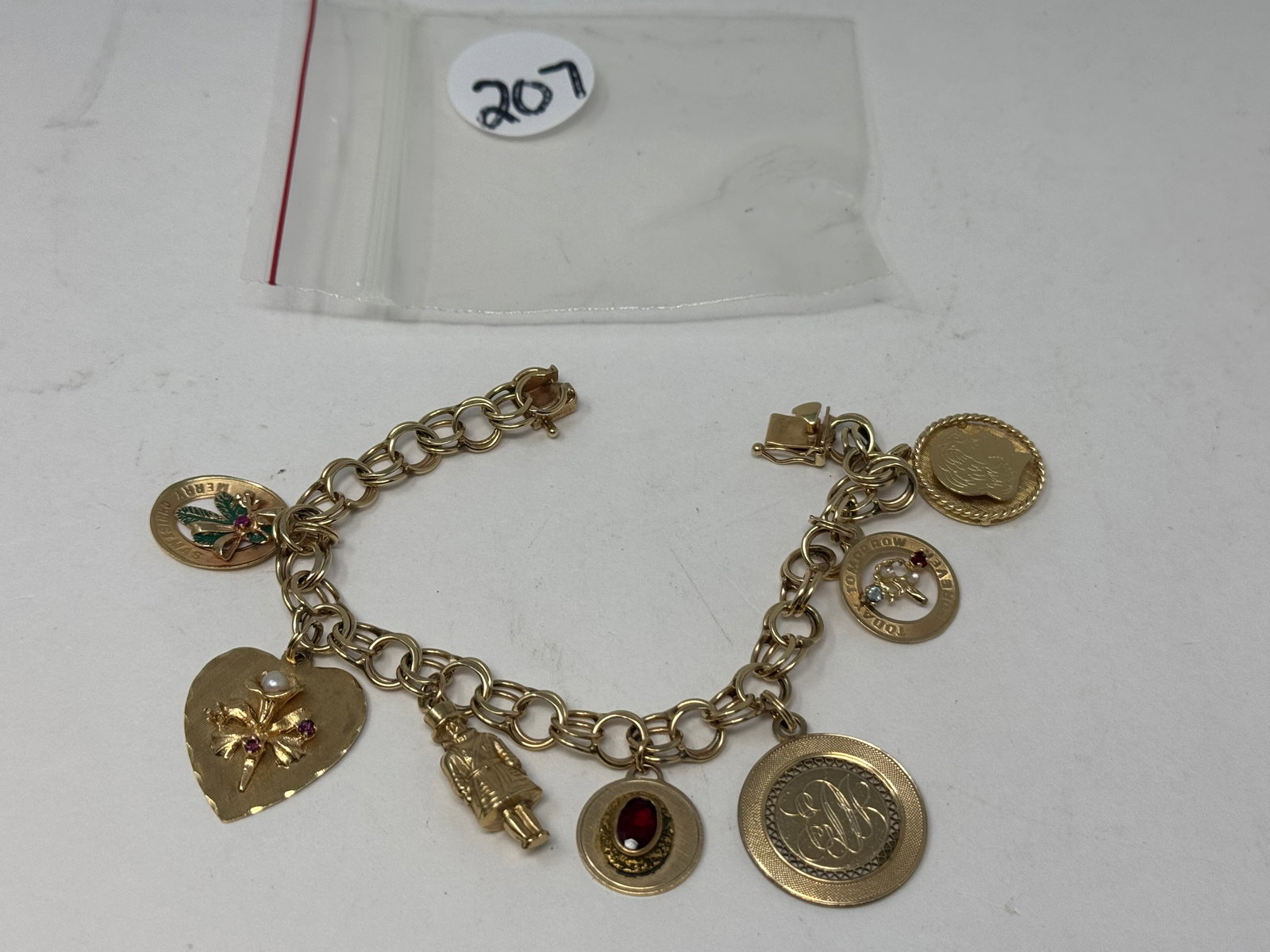 14KT Gold Charm Bracelet: marked on clasp, markings include ac14K, M&M 14K, lamode gf, aaz 14k, and others 20.6dwt. 8"L.