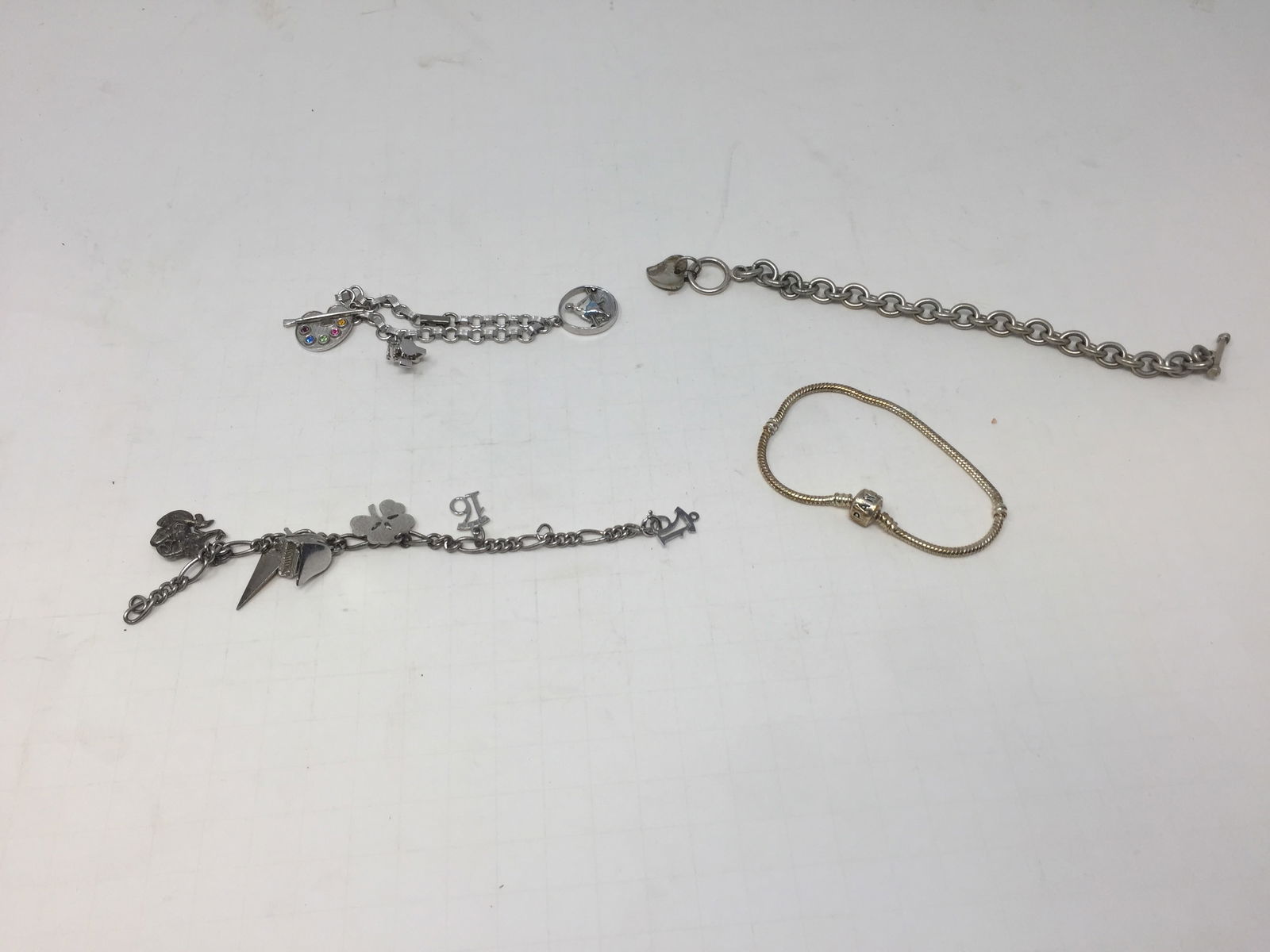 Lot of Sterling Charm Bracelets: One marked Pandora. 2.41 ozt