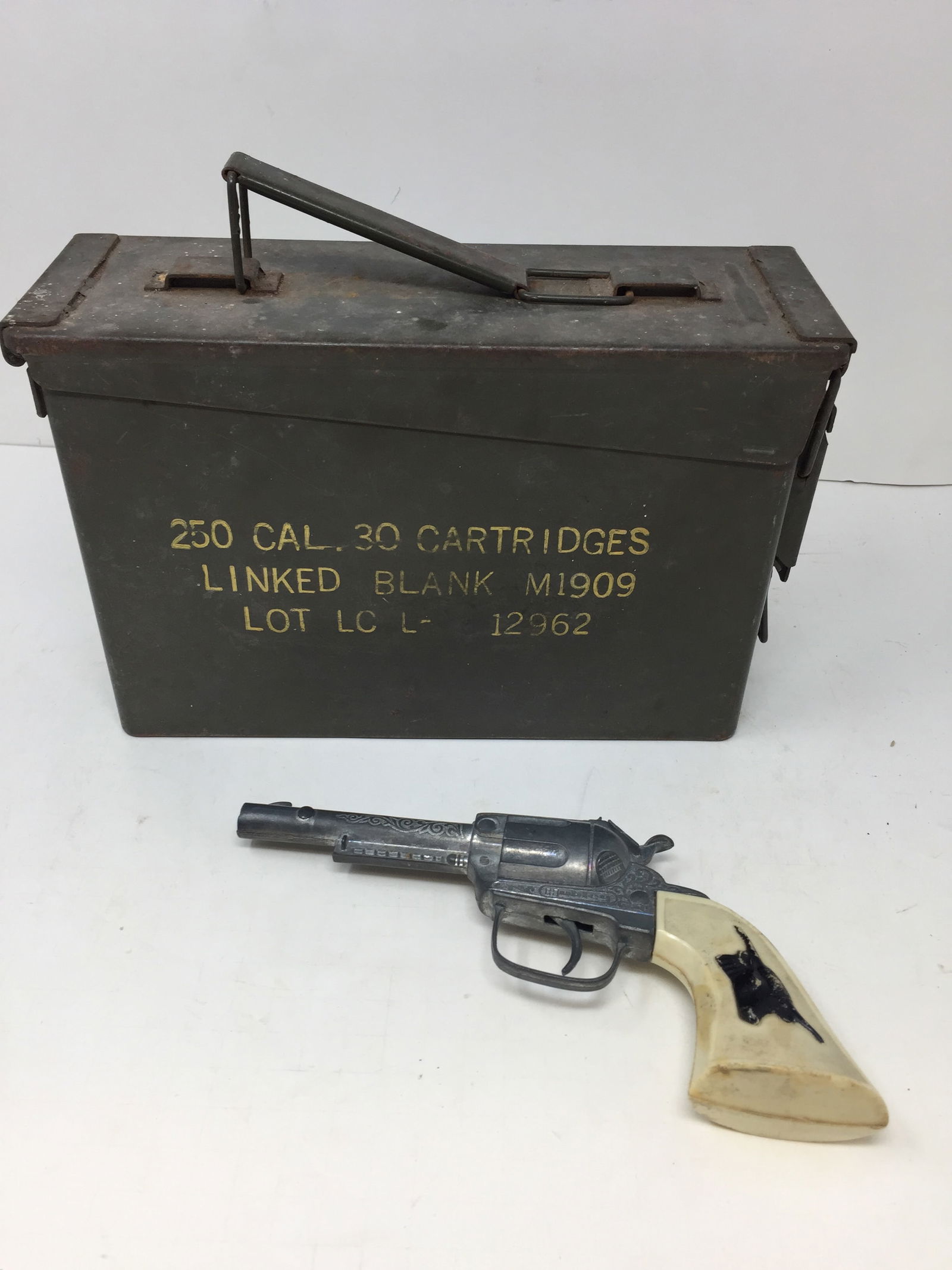 Mixed Lot: Includes a 9" Hubley cap gun and vintage ammo box.