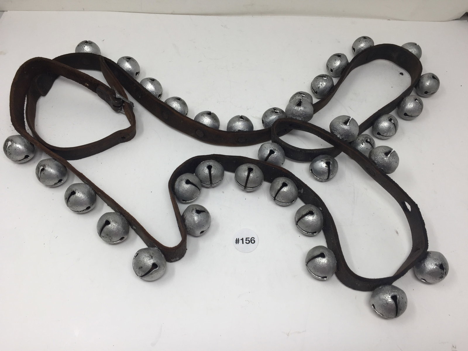 Large Stand of Antique Sleigh Bells: 35 bells, on original strap with buckle. over 6'L.