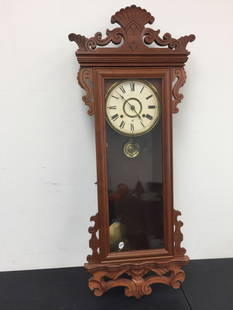 Antique Regulator Clock: carved walnut case is 16" x 4" x 40",includes key & pendulum.
