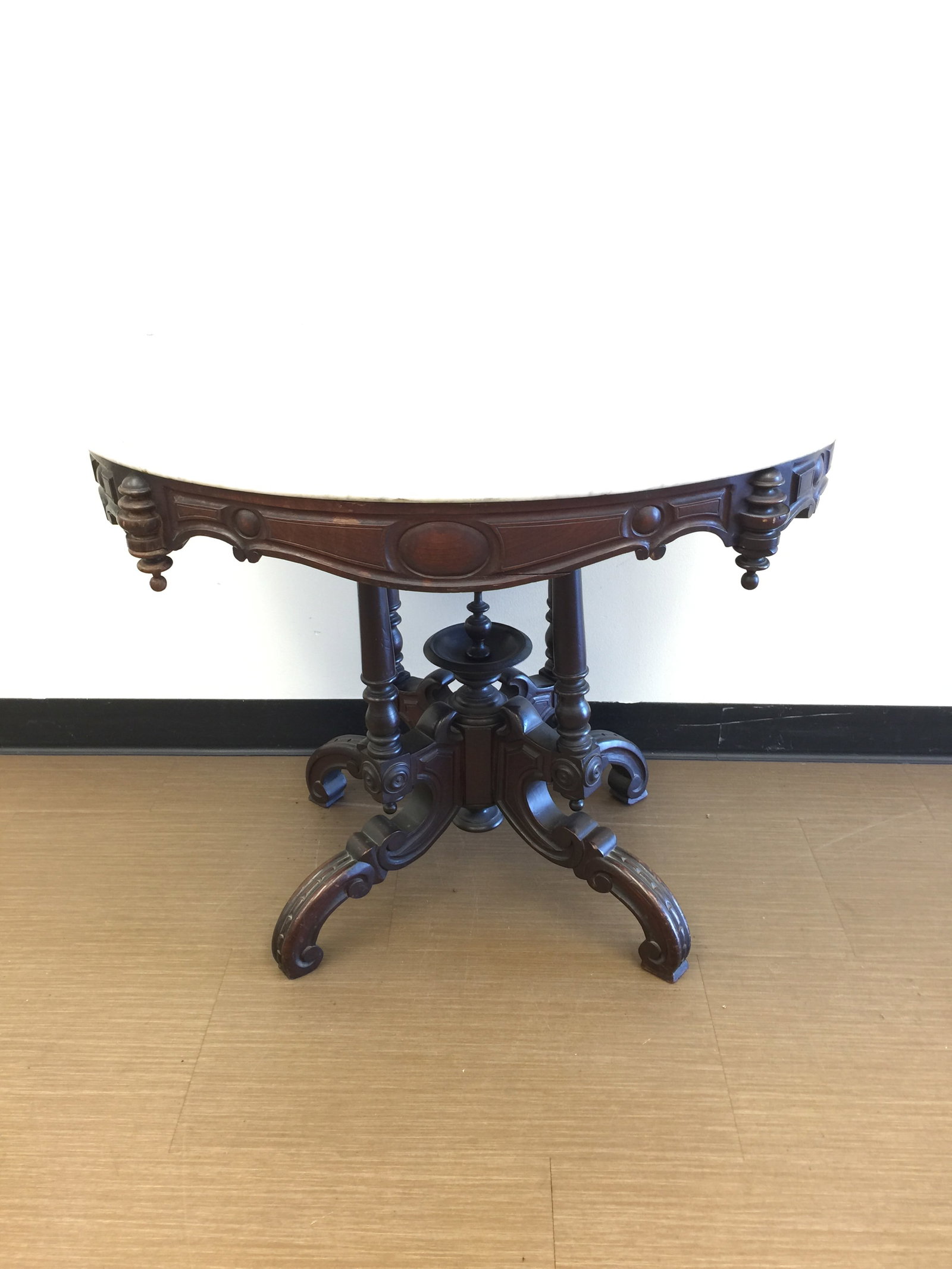 Victorian Marble Top Table: 34" x 25" x 29". Sits on highly carved walnut base.