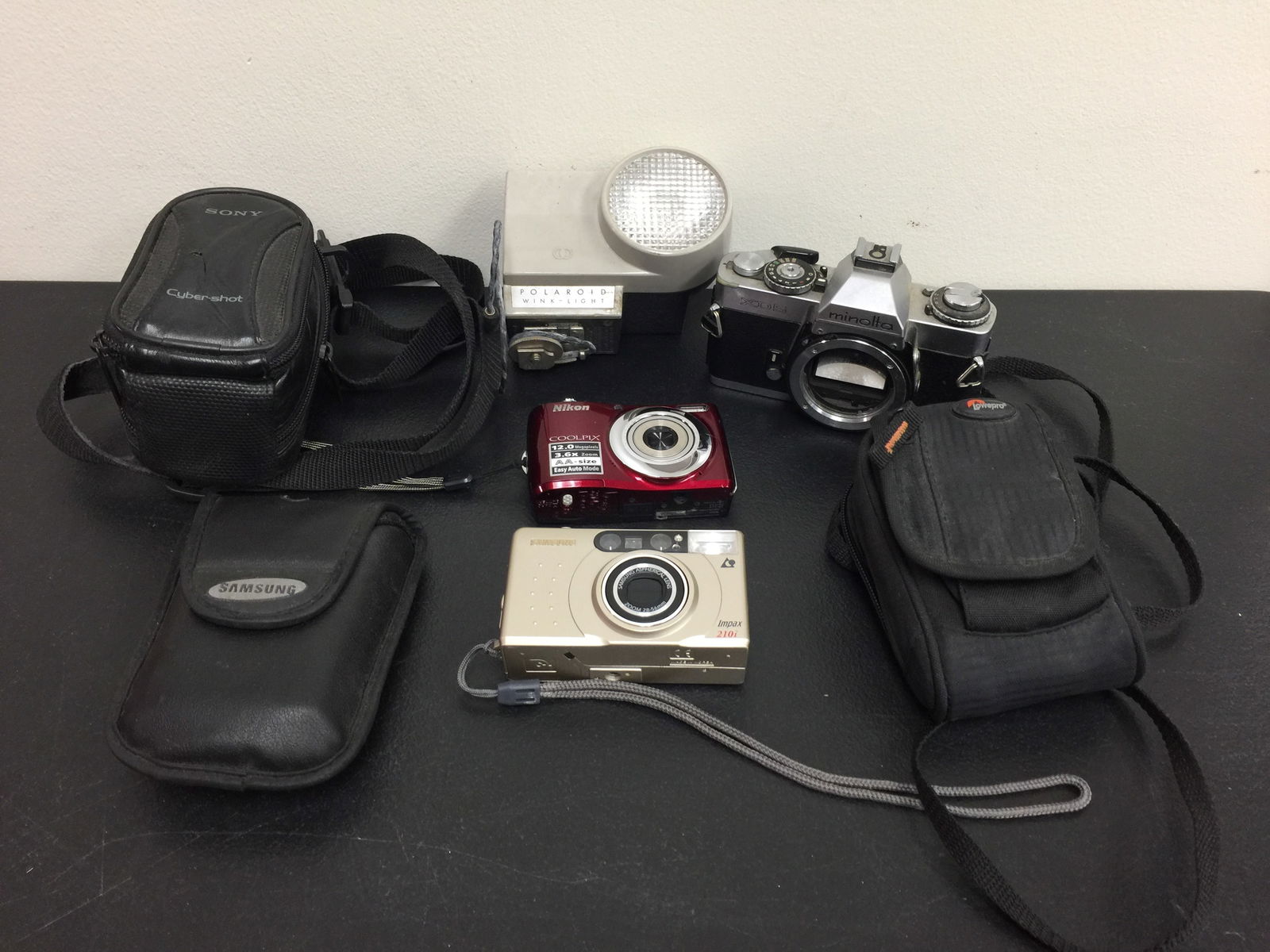 Camera Lot: Includes a Minolta, Polaroid Wink light, Nikon Coolpix and a Samsung.