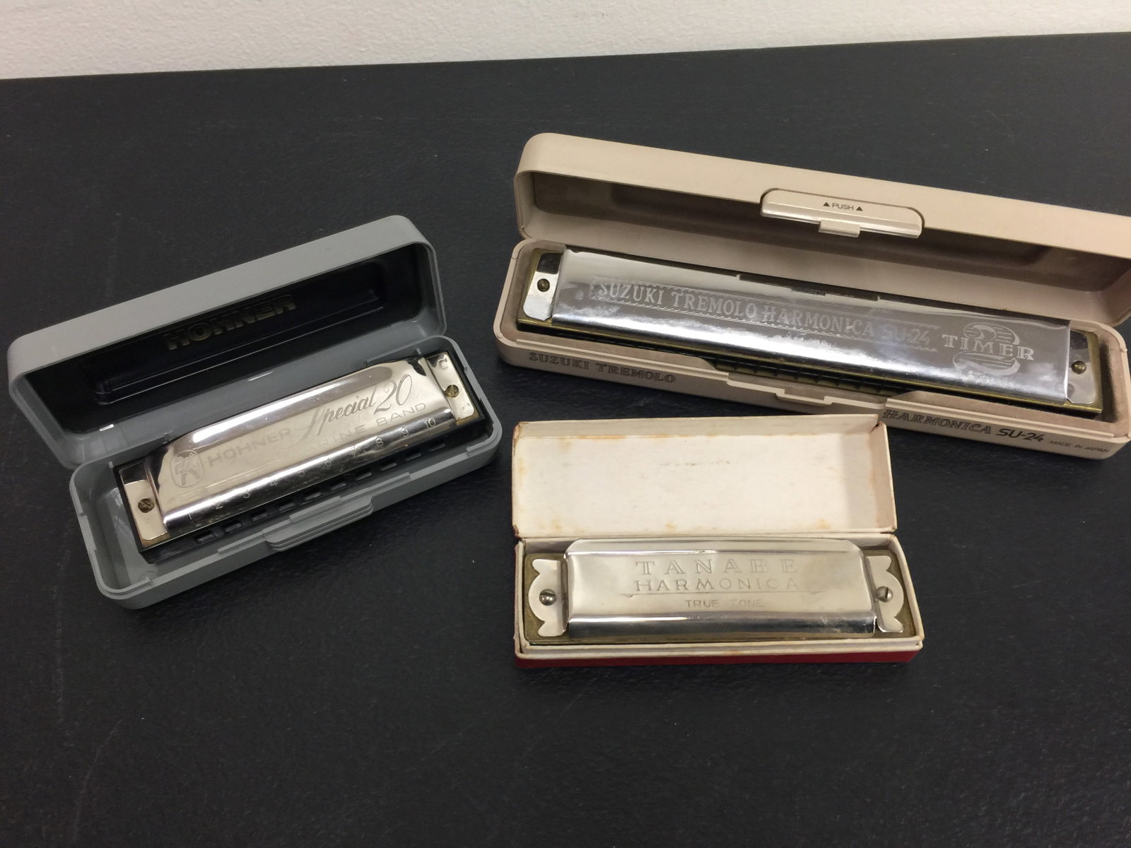 3 Harmonicas: Includes a Hohner, Tanave, and a Suzuki Tremolo. Largest 7".