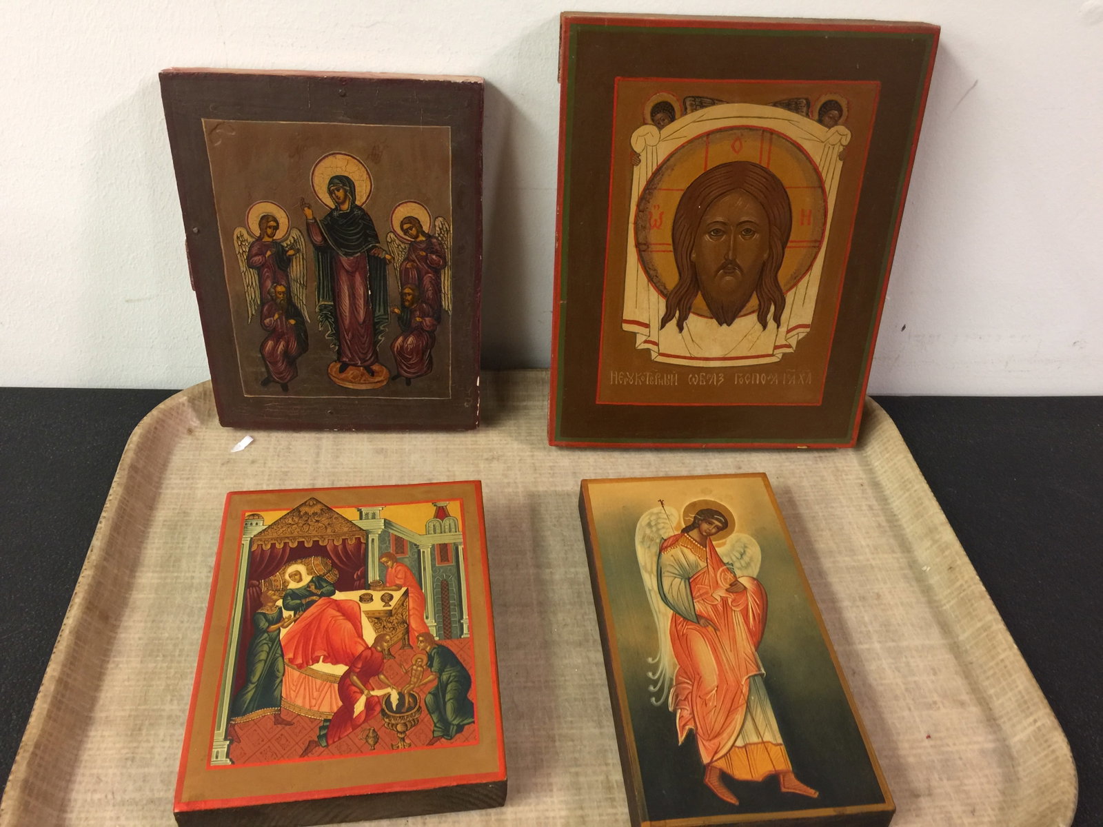 4 Russian Ikons: All painted on wood. Largest 7" x 9".