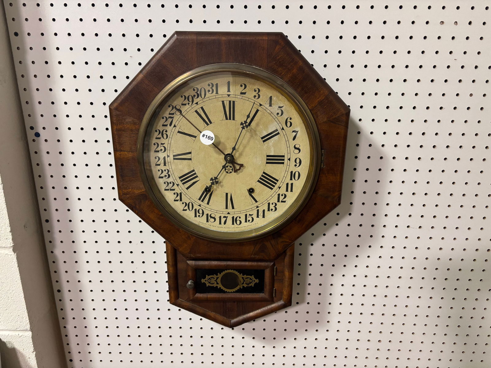 New Haven Calendar Clock: has key, pendulum, original label in interior, 23"x17".