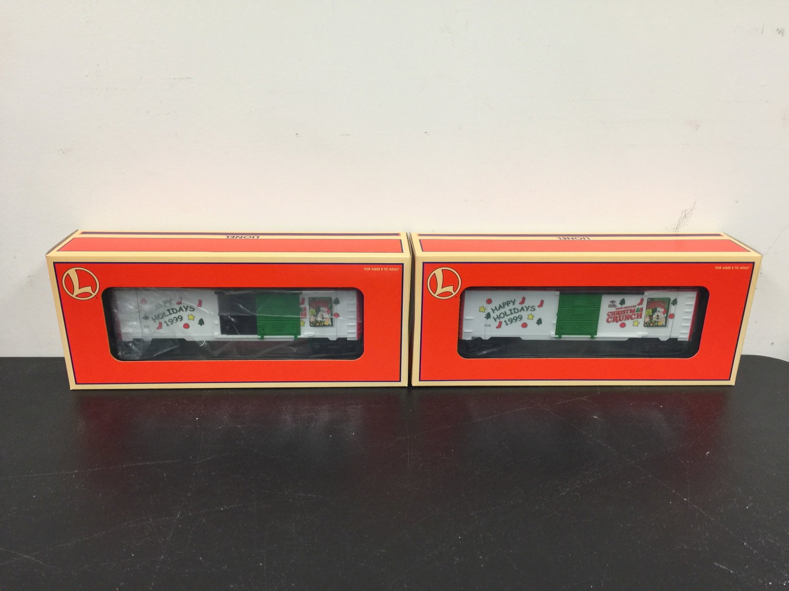 2 Lionel Train Cars: Happy Holidays 1999 & Christmas Crunch. In OB.