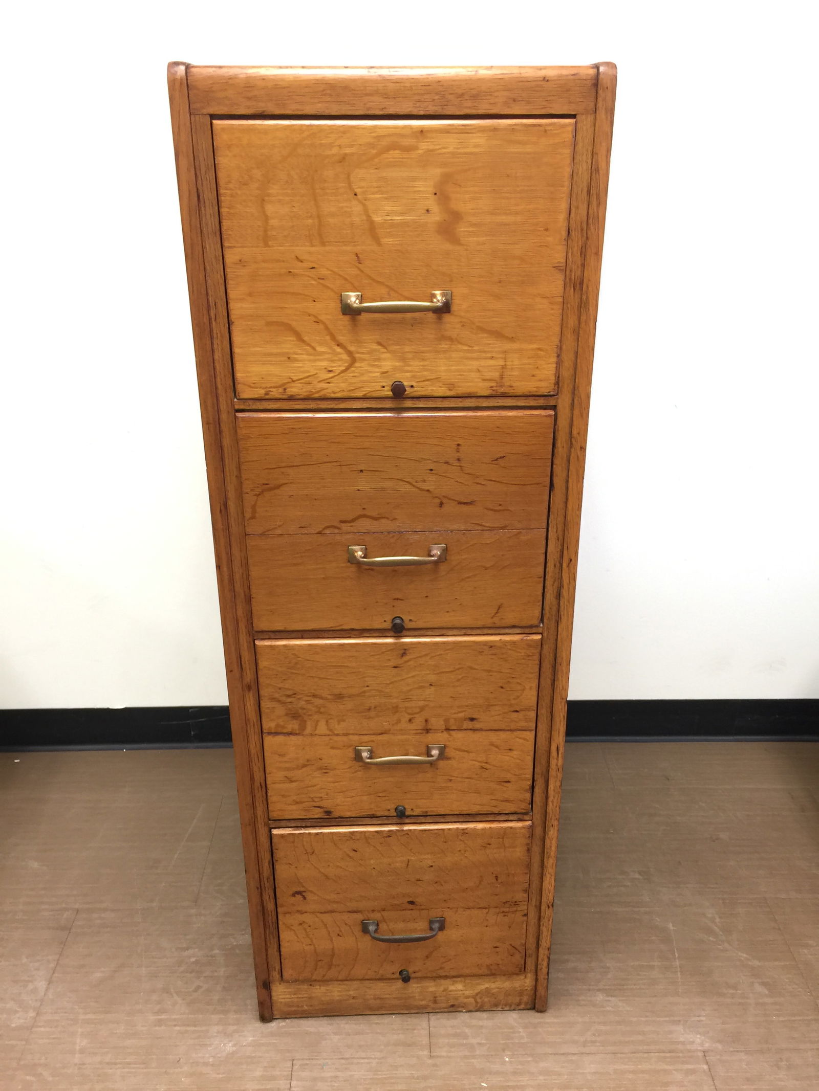 Antique Oak File Cabinet: 18" x 27" x 52". Four drawers.