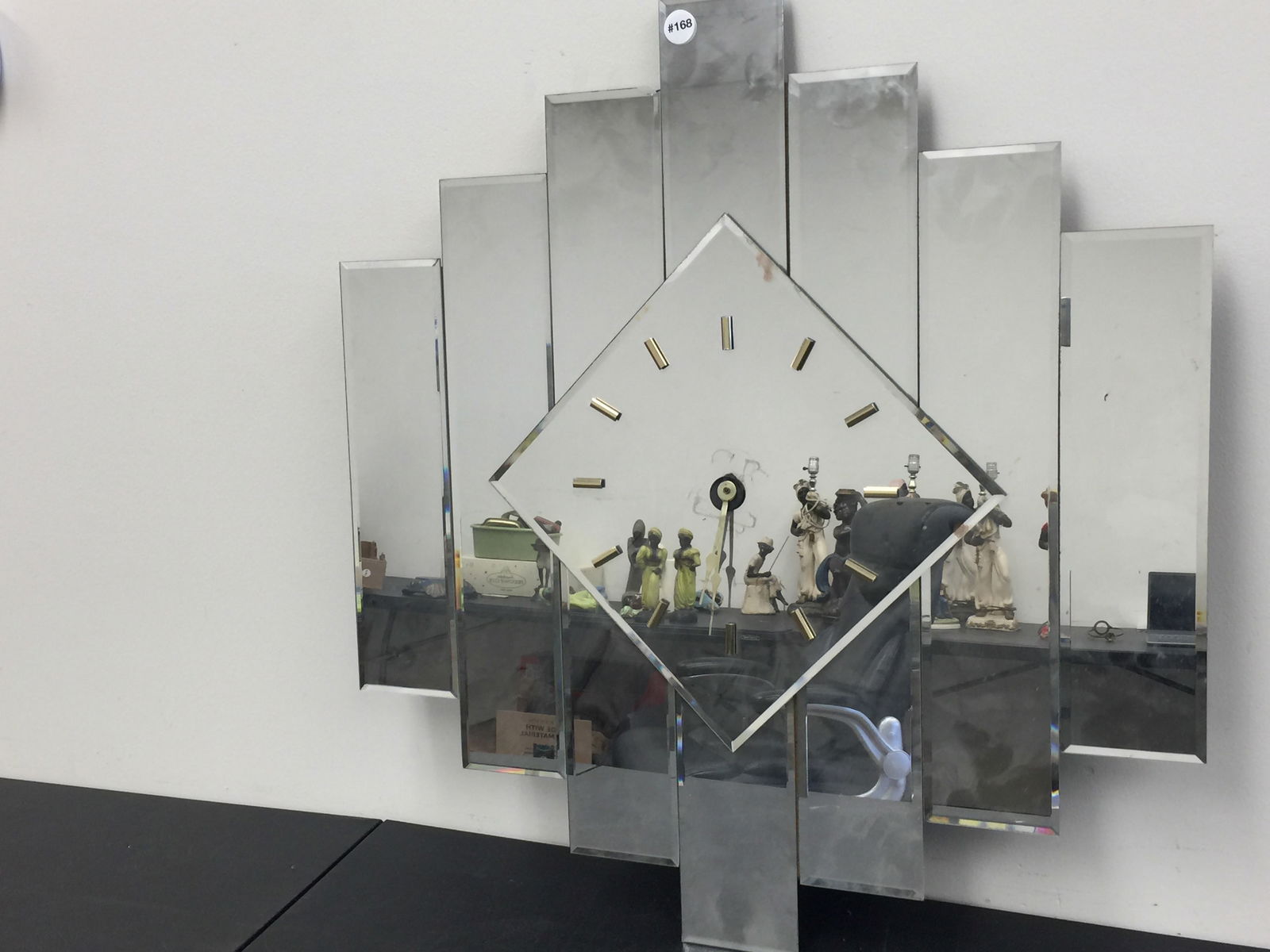 Art Deco Style Mirrored Wall Clock: Paneled, mirrored geometric pattern. 26" x 30".