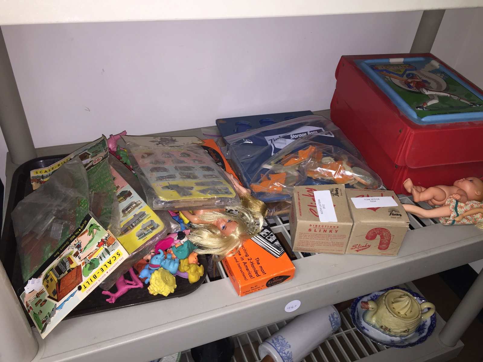 Mixed Lot: baseball card game, slinky, dolls and more.