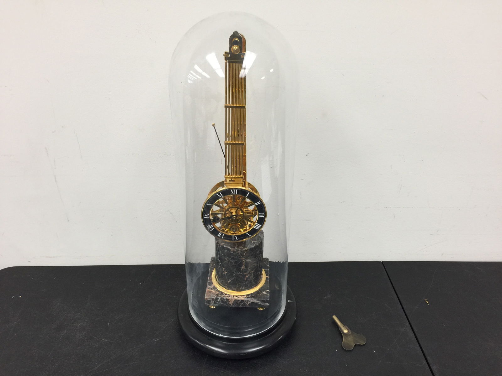 French Skeleton Mystery Clock: Has key. Enamel face signed "Huguenin A Paris". Sits on marble base. Clock 20" H, with dome 24" H.