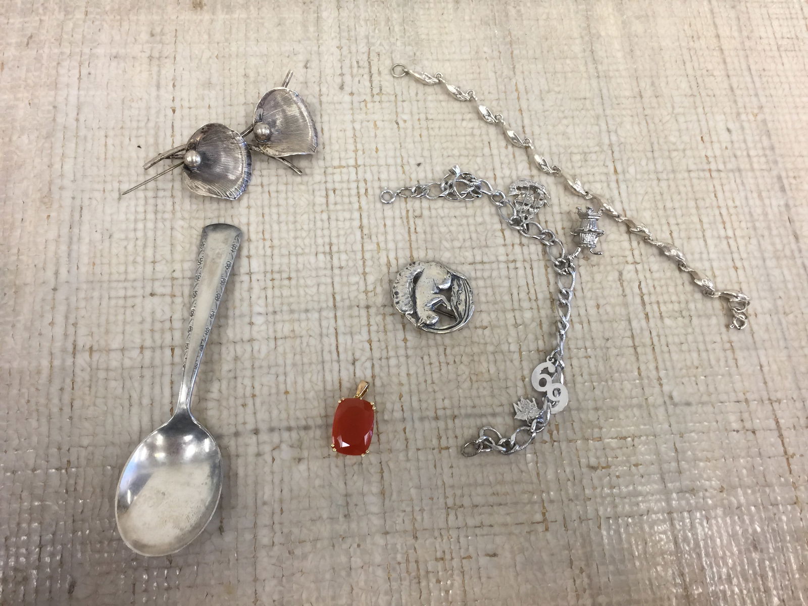 Sterling Jewelry Grouping: Includes sterling charm bracelet, (2) .925 pins, dolphin bracelet & other sterling. 3.010 ozt