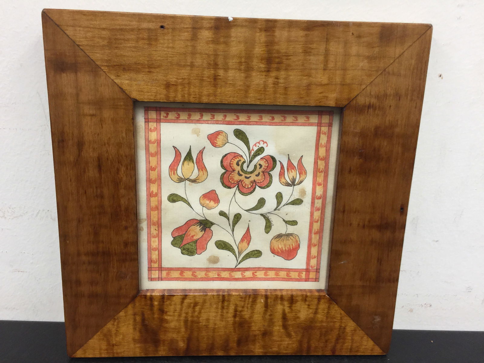 P. Golliot Watercolor Fraktur: floral design, signed on leaf, tiger maple frame. 8"x8".