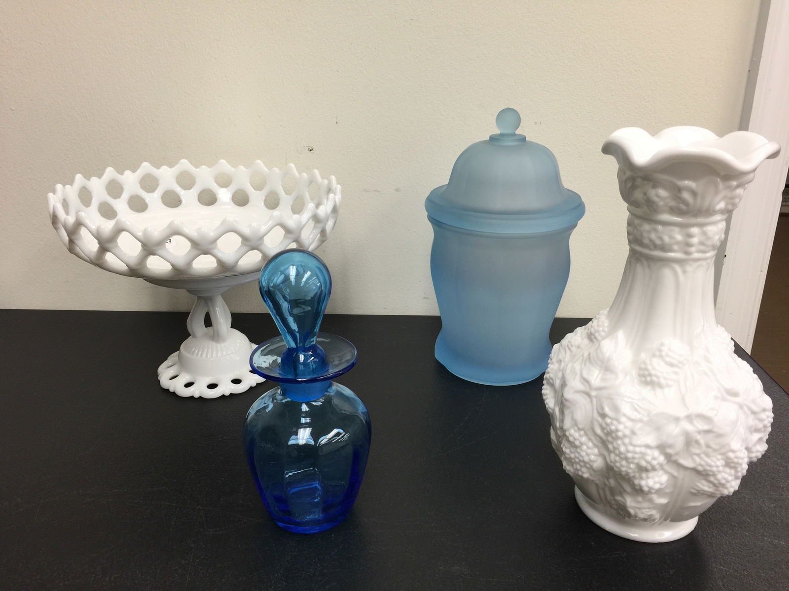 Glassware: Includes a 10" H milk glass vase, frosted blue covered jar, plus.