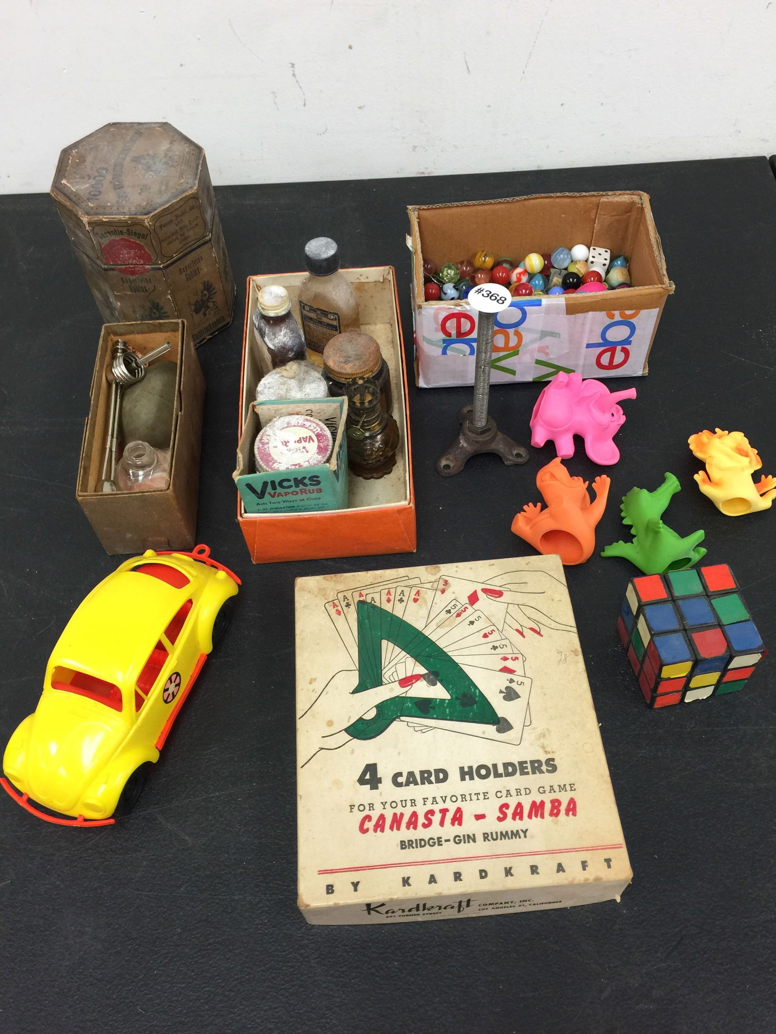 Mixed Lot: Includes vintage marbles, advertising bottles, plastic VW Bug model, Rubiks Cube and more.