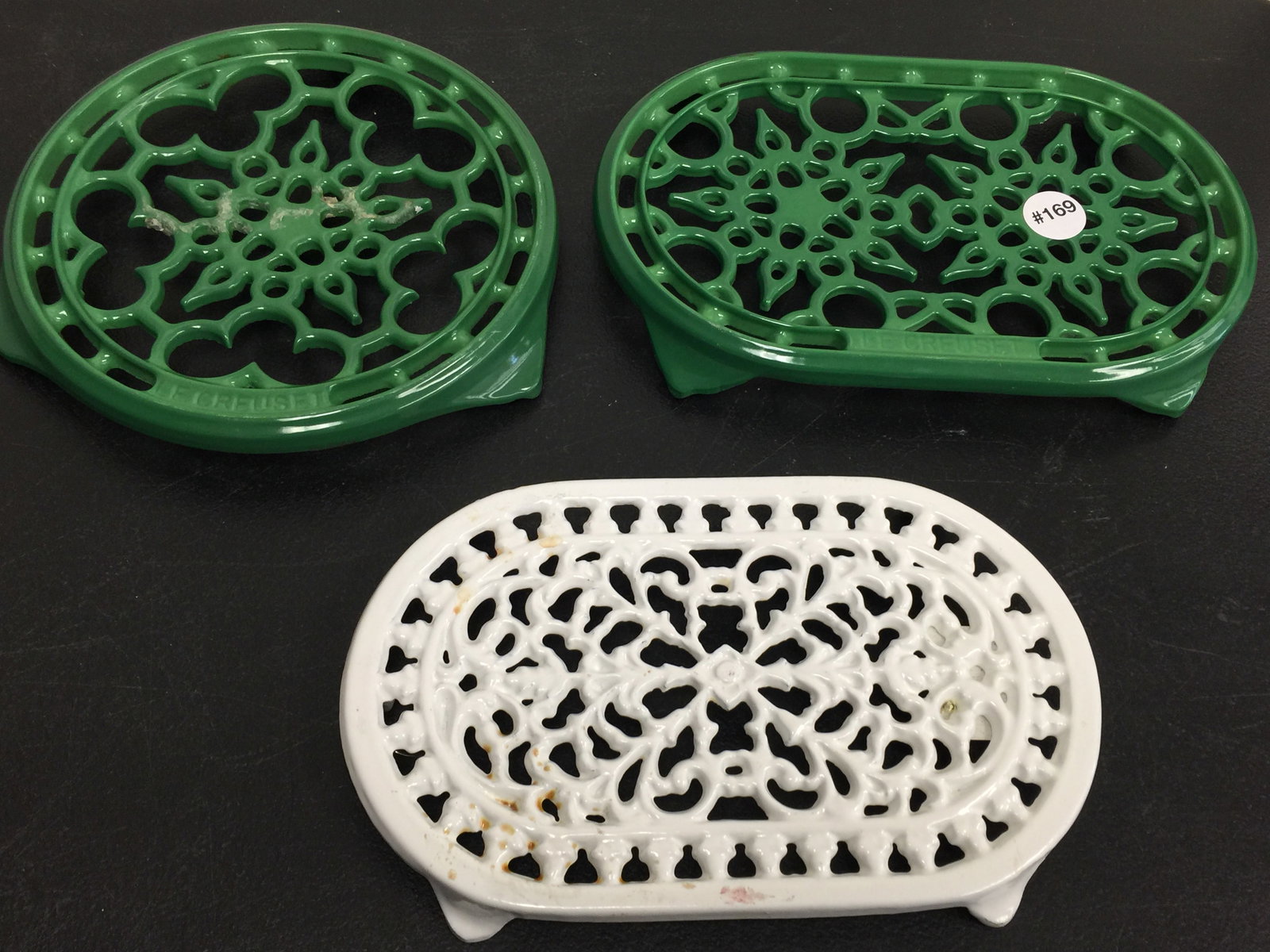 3 Cast Iron Trivets: Two green trivets are Le Creuset. LArgest 10".