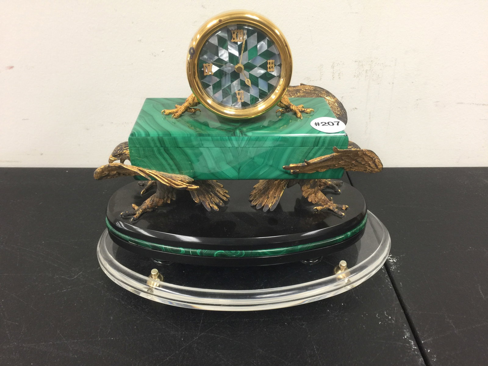 Russian Malachite Clock: Lift lid clock with bronze double eagle base. Sits on lucite base, bottom is made of alabaster. Clock 9" x 8", extra lucite base 10" L.