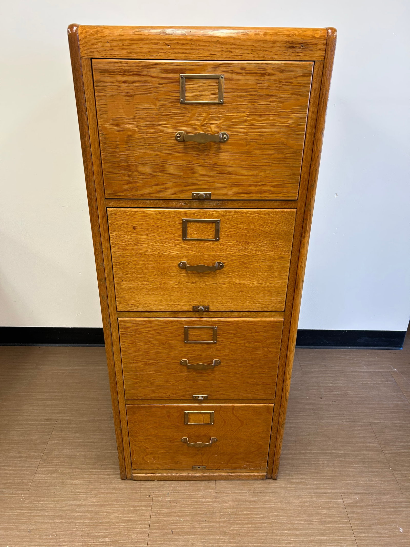 Antique Oak File Cabinet: 21" x 27" x 52". Has matching hardware.