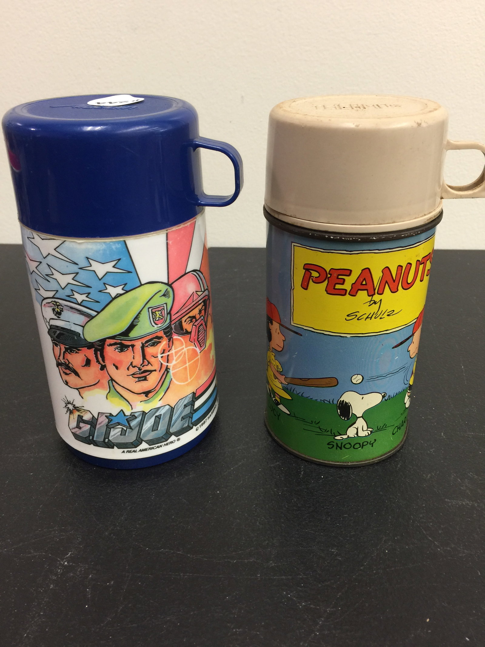2 Thermos: Both 6.5" H. Peanuts dated 1959. Also, a GI JOe Thermos.
