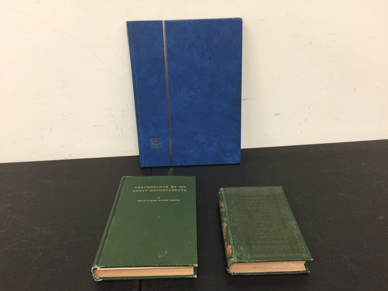 2 Books & Stamps: Includes Descendants of My Great Grandparents, copyrighted 1924 and The Hero's by Charles Kingsley. Also, a book with assorted vintage stamps.