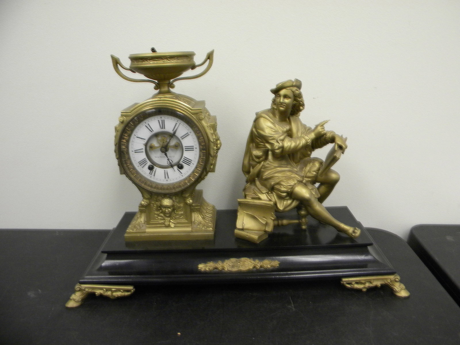 New Haven Figural Slate Mantle Clock: Marked on works. Includes key & pendulum. Beveled glass, hoof feet with slate base. 21" x 15".